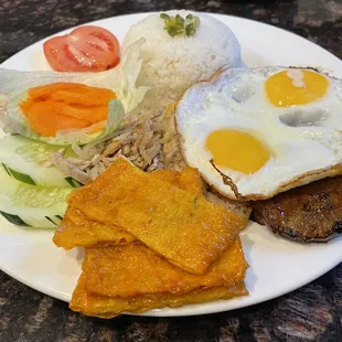 Com dac biet - Broken Rice with pork chop, shredded pork skin, Pork egg custard, fried egg, and bean curd skin