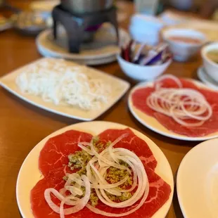 a variety of meats on plates