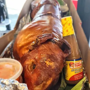 Litson served with achara,sawsawan, and mang tomas.