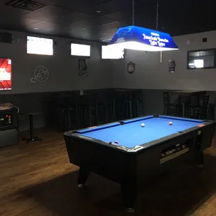 a pool table in the middle of the room