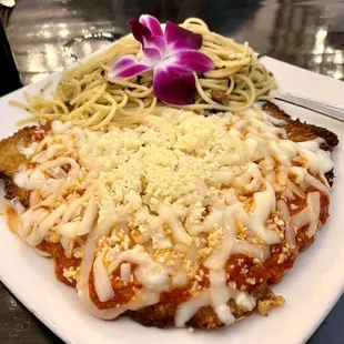 Veal Parmiggiano with side of Aglio Olio pasta