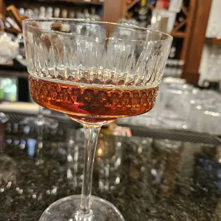 a glass of wine on a bar