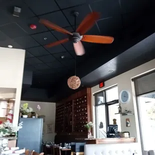 a dining area with a ceiling fan
