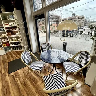 a table and chairs in front of a window