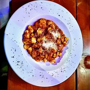 a plate of pasta on a wooden table