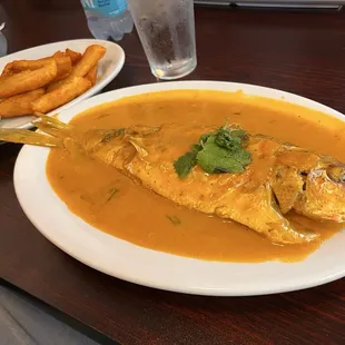 Pargo Entero Al Ajillo (Red Snapper in Garlic Coconut sauce) with Yucas Fritas