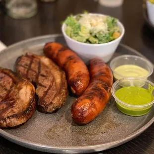 Picanha Steak Plate with extra sausage and Caesar salad.