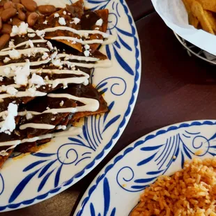 Chilaquiles rojo with a side of eggs and beans are a brunch staple on weekends and holidays. Crispy house made chips drenched in spicy sauce