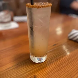 a tall glass with a drink in it