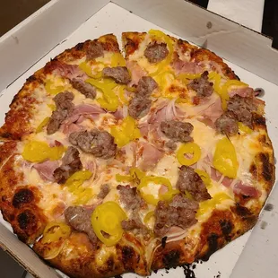 Sausage, ham, onion, and banana pepper pizza