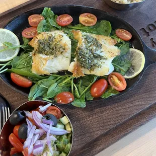 Seabass cooked Mediterranean style with salad and couscous on the side