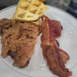 fried chicken, waffles, and bacon on a plate