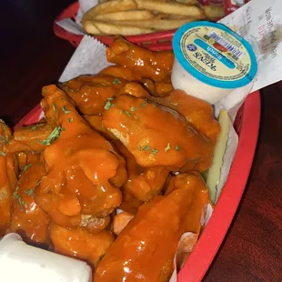 a tray of chicken wings and french fries