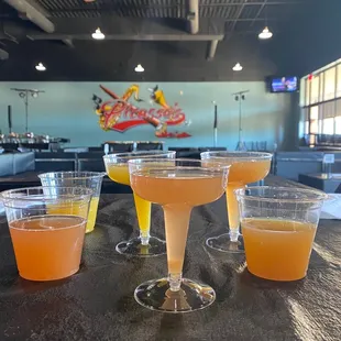 four glasses of orange juice on a table