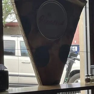 Pizza pie slice in front window