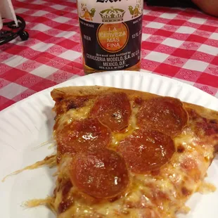 A slice of pepperoni with a bottle of Corona I brought in from a casino