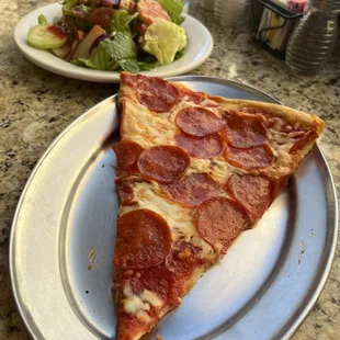 Slice of pepperoni and salad with house tomato-basil dressing. This is the real deal, my favorite slice in the world.