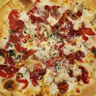 a pizza on a yellow plate