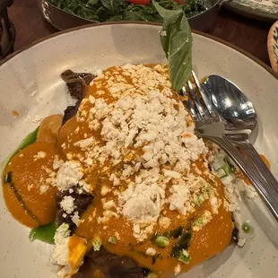 Eggplant parm in the foreground, sautéed spinach in the background