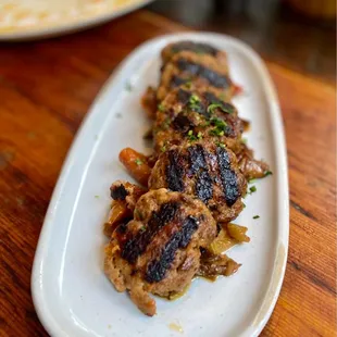Polpette di carne con caponata siciliana (meatballs).