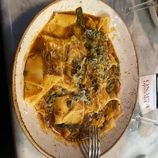 a plate of pasta and a glass of wine
