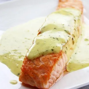 a piece of salmon covered in sauce