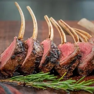 rack of lamb with rosemary on a cutting board