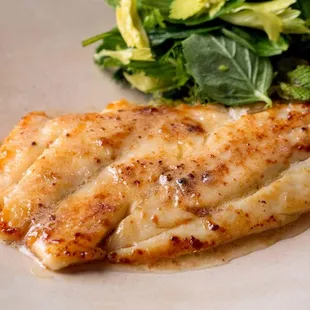 a fish fillet with a side of broccoli