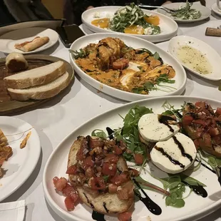 Top left: free bread sampler, middle: half destroyed tomato tower. Top right: Insalata Di Peak Bottom: Bruschetta