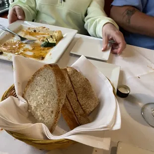 Huge Italian bread with eggplant parm In background