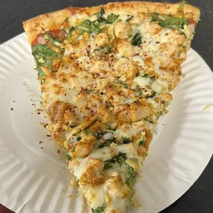 a slice of pizza on a paper plate