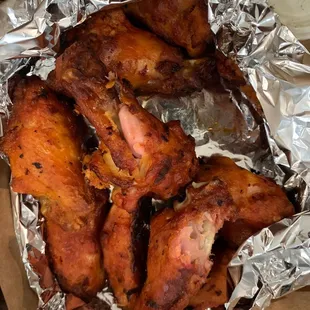 chicken wings in foil on a table