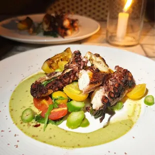 a plate of octopus and vegetables