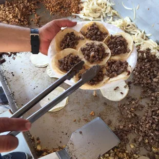 The creator of Pichos Tacos making orders for customers.