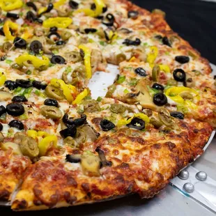 a pizza with olives and peppers