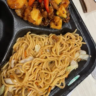 a meal of noodles, meat and vegetables