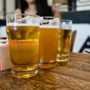 three glasses of beer on a table