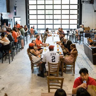 a large group of people sitting around a long table