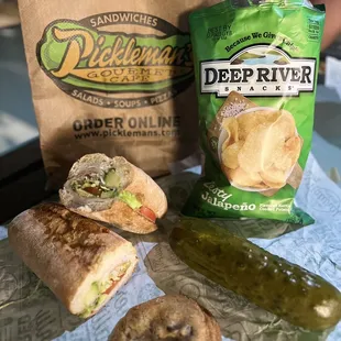 #5 with sliced avocado, a pickle, cookie and chips