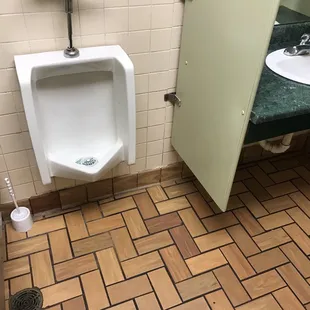 The outdated men's bathroom.
