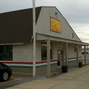 a black car parked in front of a restaurant