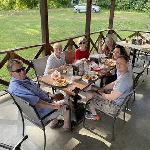 Family having a feast on the patio. Perfect for a nice summer evening.