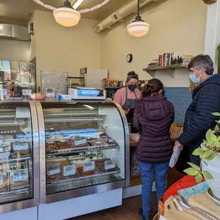 a group of people in a bakery