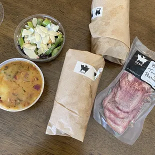 Asparagus salad on top, potato salad below, two porchetta sandwiches and beef tongue pastrami!