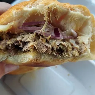 Inside of the Razorback Honey Dijon Pepper BBQ Sandwhich after a few bites. Showing the Pulled Pork.
