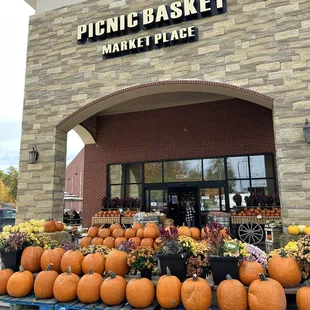 a display of pumpkins in front of a store