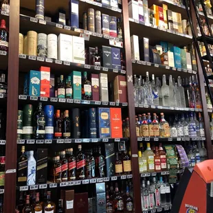 a shelf full of liquor bottles