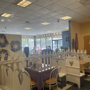 tables and booths with blue and white tablecloths