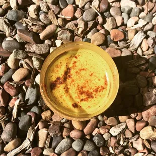 a yellow bowl of food on the ground