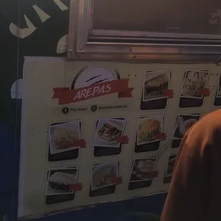 a man standing in front of a food truck